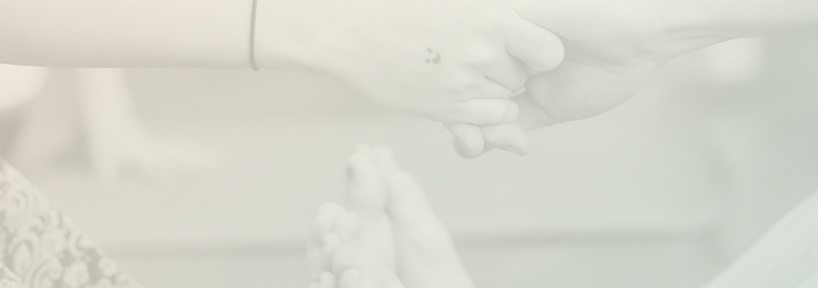 Two adults grasp hands doing a partner boat yoga pose
