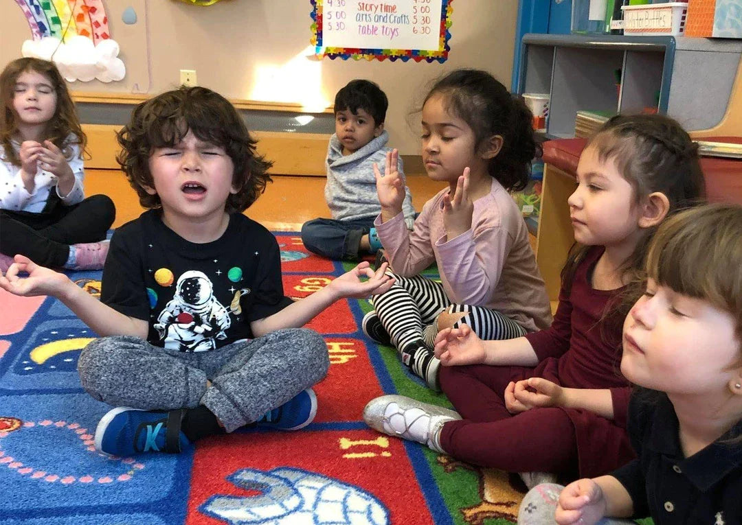Young children meditating at a Flow and Grow Kids Yoga class